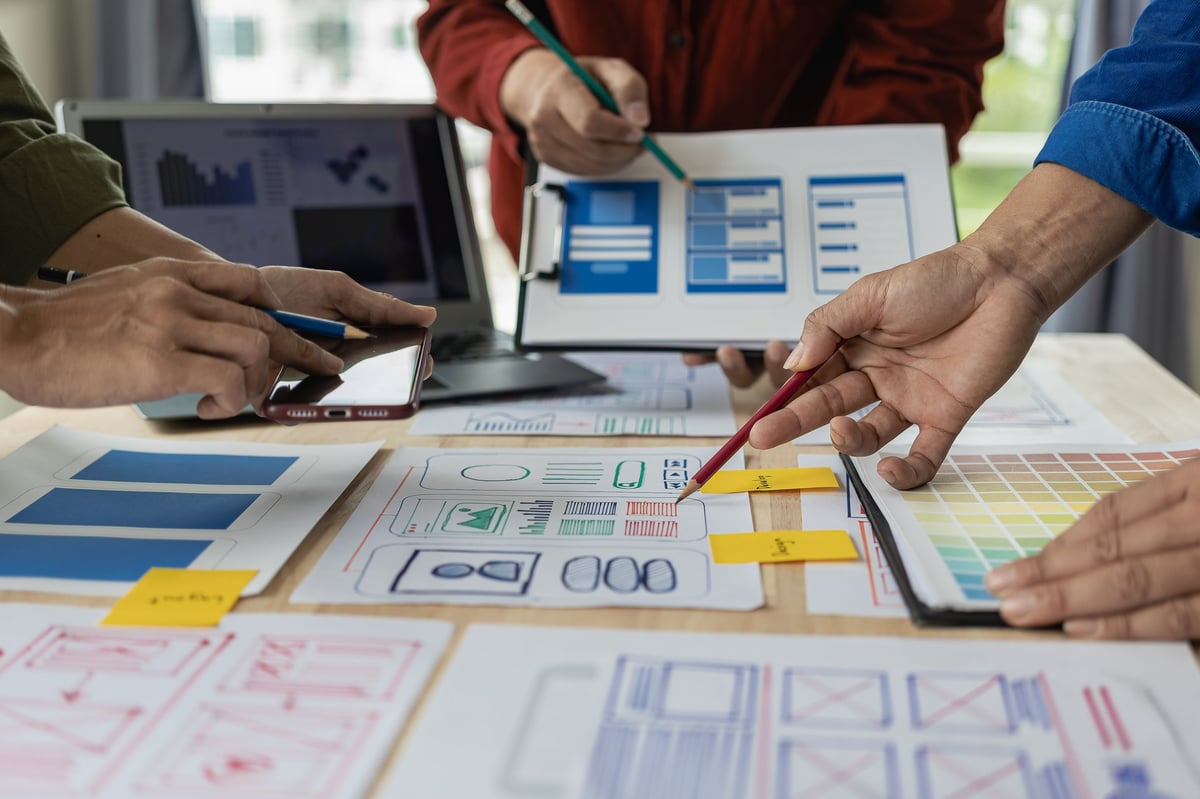 A team of web designers collaborating on a mobile responsive website